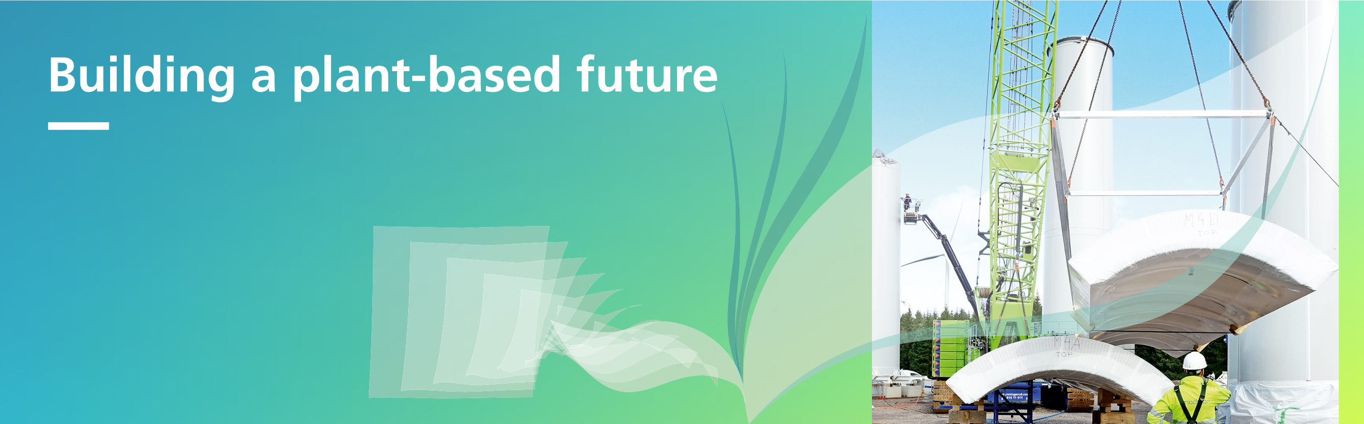The symbolic image shows the construction of a wind turbine tower.
