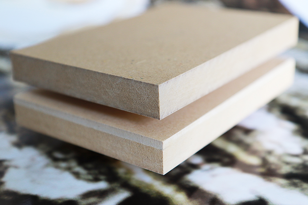 Two medium-density wood-fiber boards lying on top of one another.   