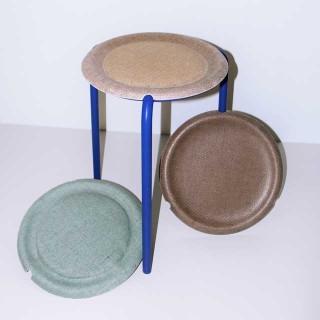 The photo shows a chair, which has a circular, upholstered seat and a metal frame. 